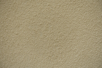 Wall Mural - Close up of wall with coarse light beige roughcast finish