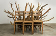 A chair made of wood and branches, in the style of Christian L opened up in the middle with chairs on each side