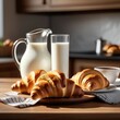 A jug of milk and a croissant with chocolate on a wooden table in a bright kitchen