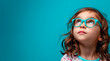 a girl with glasses on light blue background, space for text
