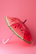 
umbrella made of watermelon isolated on pastel pink background, creative minimalist summer vacation concept
