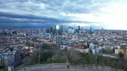 Wall Mural - Aerial view of Milan at sunset. Milan skyscrapers buildings against a background of dramatic clouds