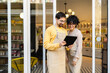 © ADDICTIVE STOCK - Small business owners using tablet in boutique shop