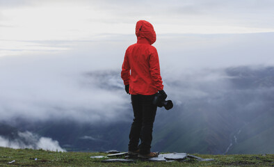 Wall Mural - Successful hiker with camera on mountain top