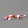 Various capsules and tablets arranged in a random pattern on a grey background