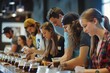 A group of individuals sitting at a long table, actively engaging in grinding beans and brewing Tywe