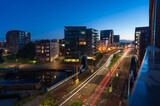 Fototapeta Las - Light trails from traffic in the city of Groningen at dawn.