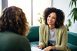 Young female psychologist talking to a client in her office