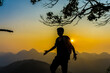 Hiking man stand on hill enjoying sunset