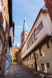 Fototapeta Natura - Scenic view old narrow european german Lubeck with red brick ancient houses vintage iron stained glass lamp lantern wall. Cityscape Lübeck UNESCO heritage city altstadt in Germany travel destination