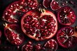A sliced pomegranate revealing its jewel-like seeds arranged artistically.