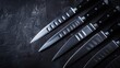 A set of sharp chefs knives, each blade reflecting the light, against a backdrop of dark stone, highlighting precision and edge low texture