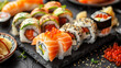 Platter of sushi rolls on gray cement background.
