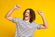 Photo of nice young man chilling dancing wear striped t-shirt isolated on yellow color background