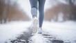 Woman's legs with sport shoes jogging or running in snow