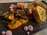 Fototapeta Natura - delicious gourmet seafood isolated plate of Paella, octopus plate un black plates 