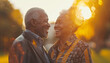 Handsome elder aged smiling grey haired African american man with beautiful wife hugging in city park, enjoying evening hours together. Calm retirement, healthy lifestyle, couple in love concept image