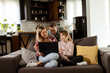 © BGStock72 - Family Bonding Time With Laptop in Cozy Home Setting