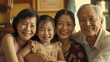 A warm family moment as two older women and an older man smile with a young girl, exuding happiness and togetherness