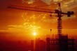 Silhouette of modern office building construction tower crane on high ground heavy industry against sunset