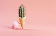 An cactus in the shape of an ice cream cone, placed on a pink background, minimal concept