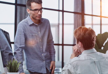 caucasian man sit at desk discuss new project or task,