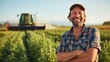 Portrait of a smiling farmer in field with cannabis plant growing in a large outdoor plantation farm.
