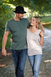 © peopleimages.com - Couple, hug and happy walking in park for bonding, love with care and support in healthy relationship. Man, woman and outdoor for date with romance, trust and commitment for marriage or partner