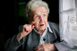 An elderly woman speaks passionately.