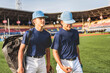 two Young teen boy play baseball on a playground