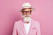 60 year old fashionable hipster man portrait on bright pink background