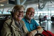 elderly couple sitting at the airport