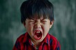 Portrait of Asian angry, sad and cry little boy on dirty grey color background, The emotion of a child when tantrum and mad, expression grumpy emotion, yelling, shouting. Kid emotional control concept
