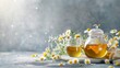 Healthy chamomile tea in glass teapot and flowers with copy space
