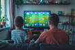 A man and a boy are playing a video game together. The boy is holding a controller and the man is watching him