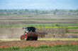 rear view of tractor preparing the fields for cultivation