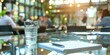 © savitch - Glass of Water on Reflective Table with Meeting in Background
