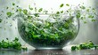   A glass bowl brimming with verdant plants and water cascading over its rim into the air