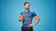 portrait of a person, A male athlete wearing gym attire stands alone against a blue backdrop, clutching a squeeze bottle., man holding a dumbbell