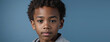An African American Kin Boy, Isolated On A Blue Background With Copy Space