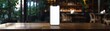 Smartphone with a blank white screen standing on a wooden table in a cozy cafe environment