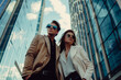 Fashionable luxury couple in the city, copy space of man and woman in suits in skyscrapers of wealthy people