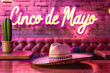 pink sombrero in festive restaurant with cinco de mayo neon sign and cactus