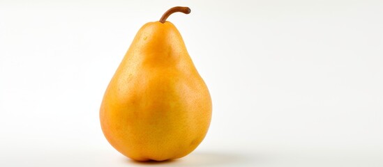 Wall Mural - Close-up image of a fresh pear resting on a clean white tabletop with a plain white background, highlighting its natural beauty