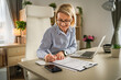 © Miljan Živković - Mature woman businesswoman sign document contract at office at work
