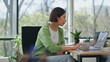 Business lady holding coffee sitting office desk close up. Girl looking laptop