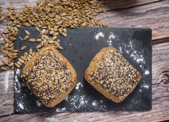 Top view of two pieces of whole wheat bread with seeds.