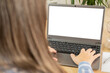 Over shoulder view girl looking at empty blank white mockup, distance learning course, using computer, monitor with white screen mockup, self-education, digital age, prevention cybercrime, screen time