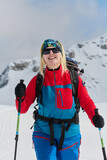Fototapeta  - A Female Mountaineer Ascends the Alps with Backcountry Gear