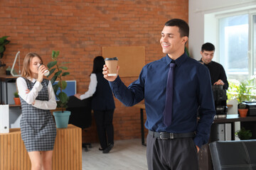 Wall Mural - Young businessman having coffee break in office